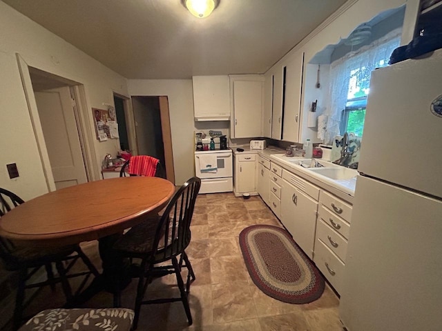 kitchen with white appliances and white cabinetry