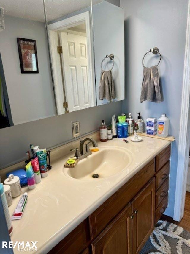 bathroom with vanity and hardwood / wood-style floors