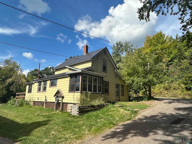 view of home's exterior featuring a lawn