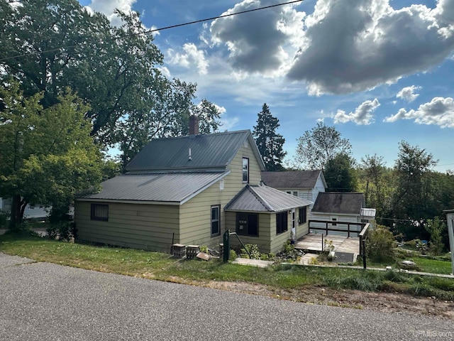 view of home's exterior featuring a wooden deck