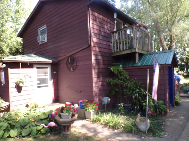 view of side of home with a balcony