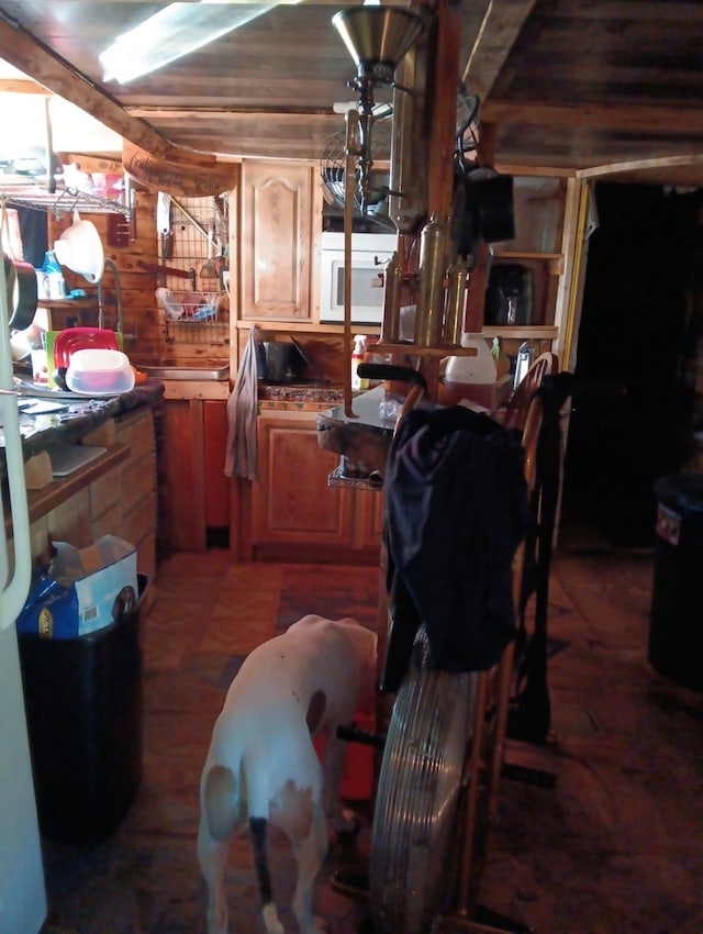 kitchen with wood walls and wooden ceiling