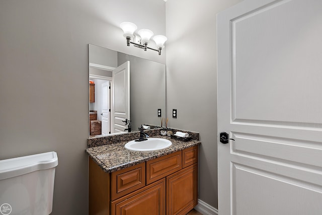 bathroom featuring vanity and toilet