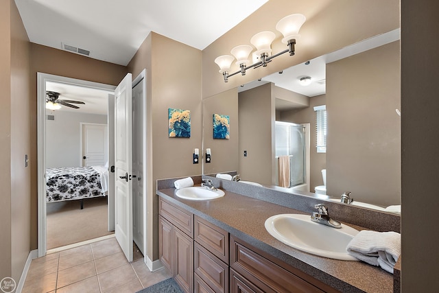 bathroom featuring ceiling fan, vanity, toilet, walk in shower, and tile patterned flooring