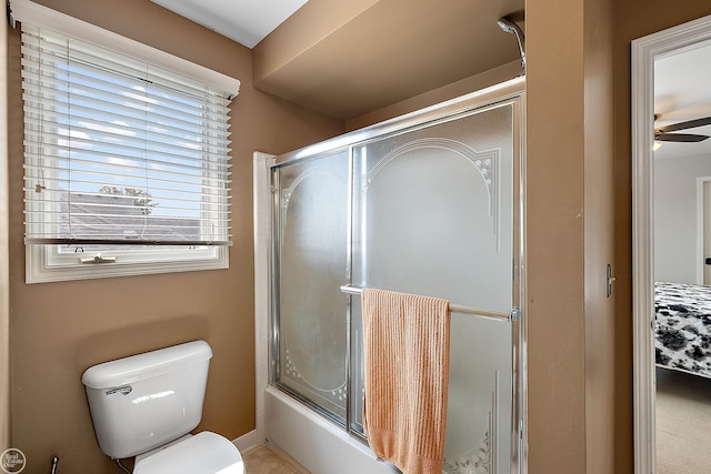 bathroom featuring shower / bath combination with glass door, toilet, and ceiling fan