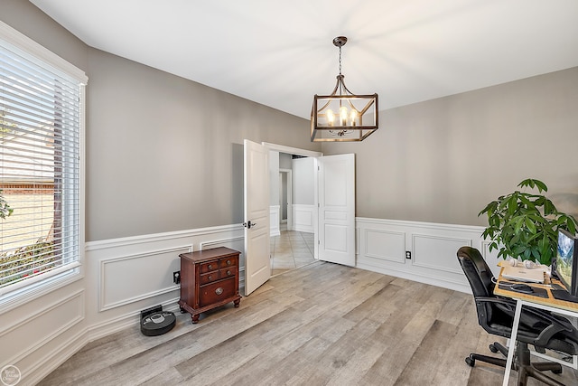 office space featuring light hardwood / wood-style floors and a chandelier