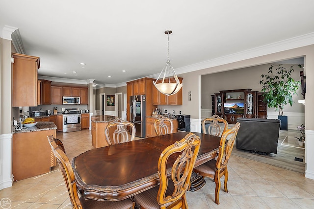 tiled dining area with crown molding and ornate columns