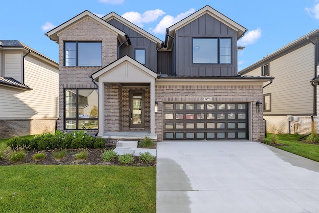 view of front of home featuring a garage and a front lawn