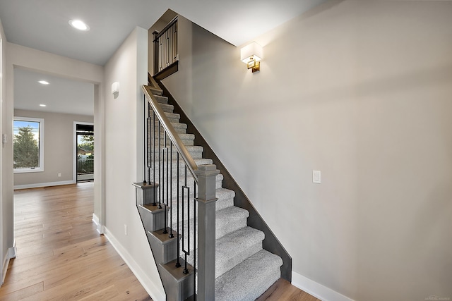 stairs with hardwood / wood-style flooring