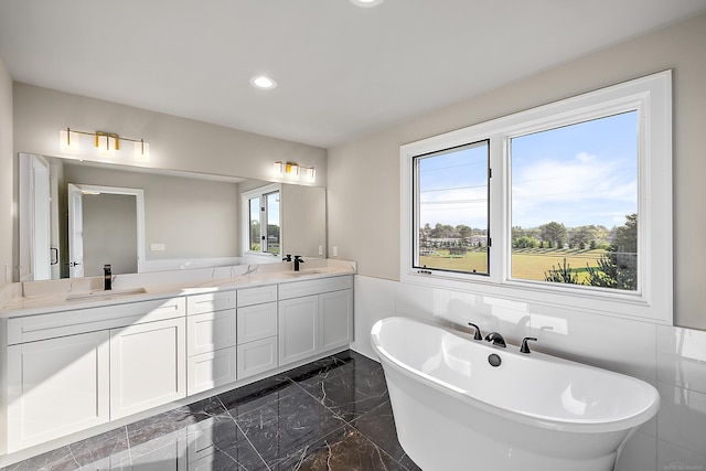 bathroom with vanity and a bath