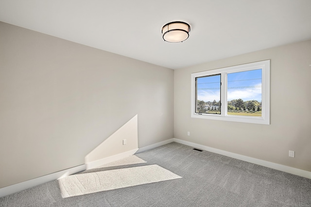 empty room featuring light colored carpet