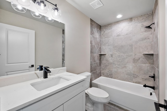 full bathroom with tiled shower / bath combo, vanity, and toilet