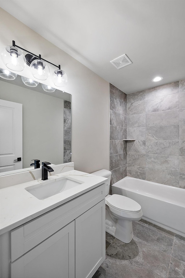 full bathroom featuring vanity, toilet, and tiled shower / bath