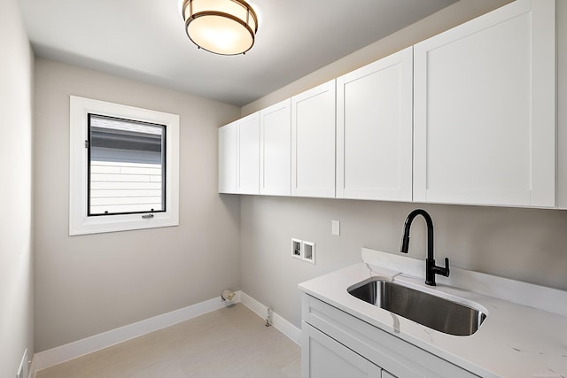 clothes washing area featuring hookup for a washing machine, sink, and cabinets