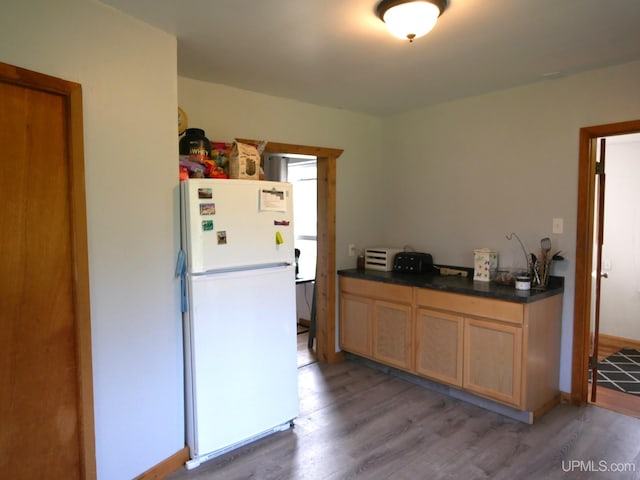 kitchen featuring light hardwood / wood-style flooring and white fridge