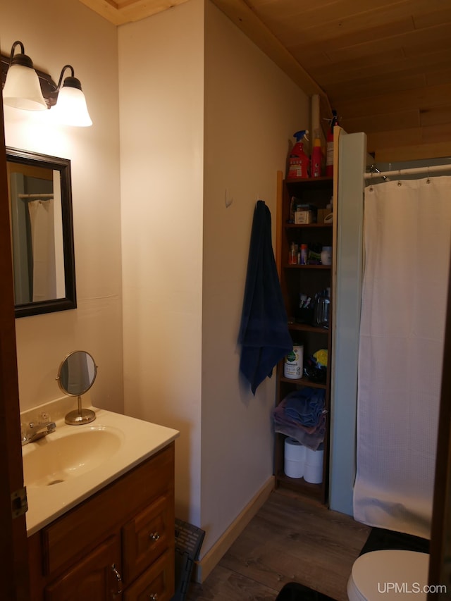 bathroom with vanity, wood ceiling, hardwood / wood-style flooring, walk in shower, and toilet