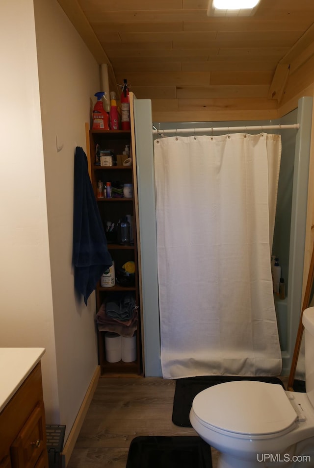 full bathroom featuring vanity, hardwood / wood-style flooring, wooden ceiling, toilet, and shower / tub combo with curtain