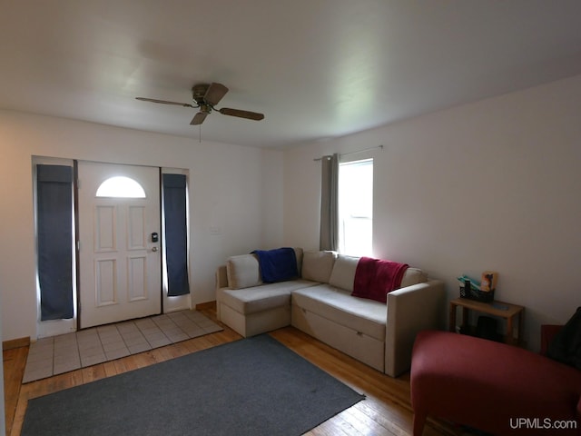 living room featuring ceiling fan and light wood-type flooring