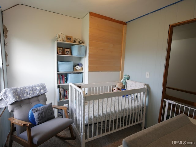 bedroom featuring wood walls and carpet floors