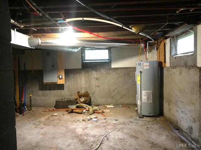 basement featuring water heater and electric panel