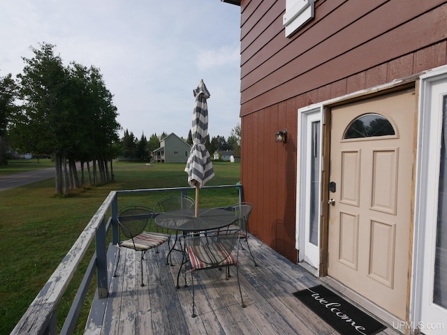 wooden terrace with a yard