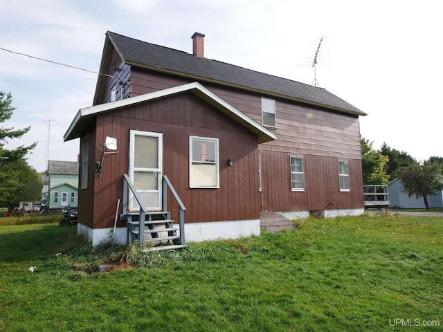 rear view of house with a yard