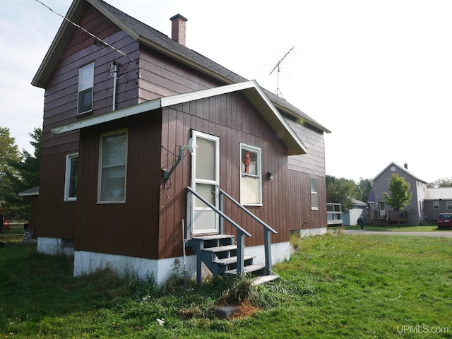 view of side of home featuring a lawn