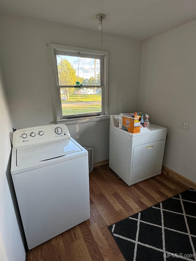 laundry area featuring washer and clothes dryer and hardwood / wood-style floors