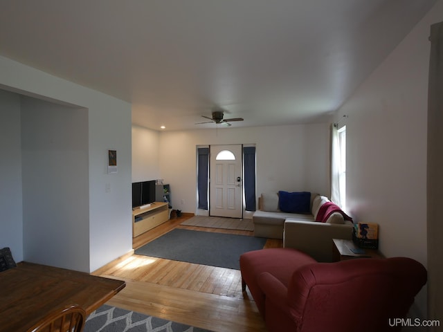 living room featuring light wood-type flooring and ceiling fan