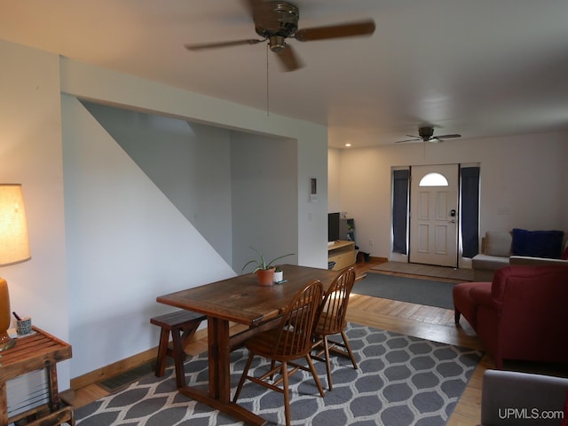 dining area with ceiling fan and hardwood / wood-style flooring