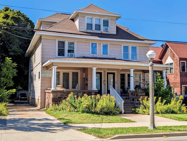 view of front of house with cooling unit and a porch