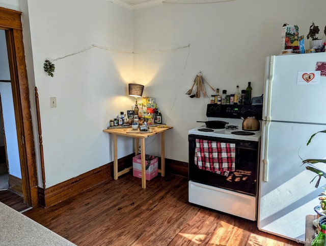 kitchen with hardwood / wood-style floors and white appliances