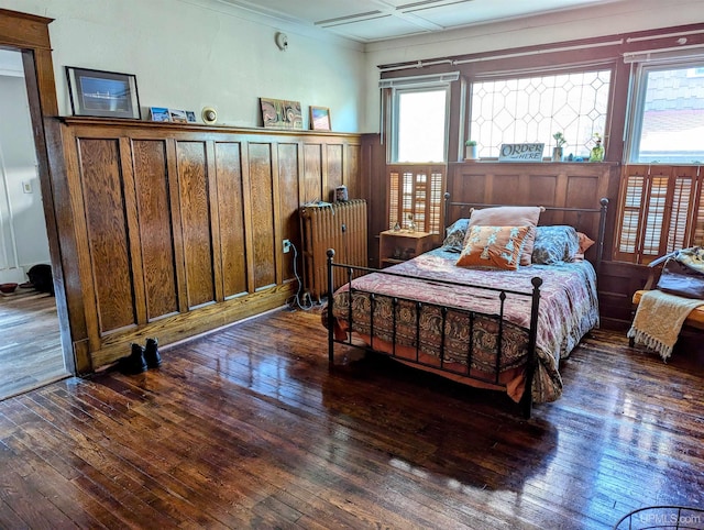 bedroom with radiator and dark wood-type flooring