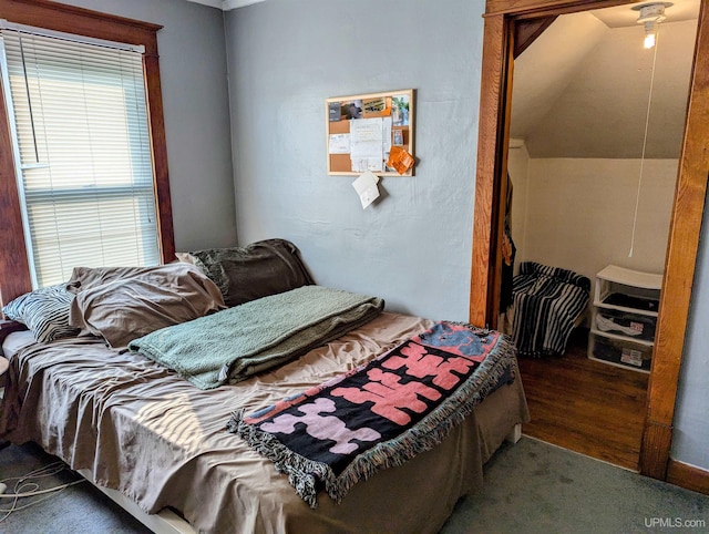 bedroom featuring vaulted ceiling and hardwood / wood-style floors