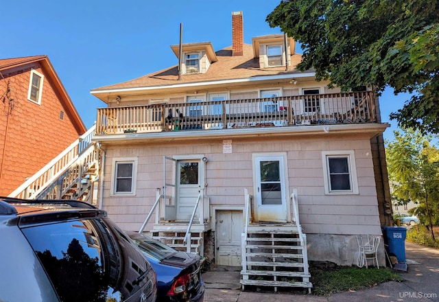 back of property featuring a balcony