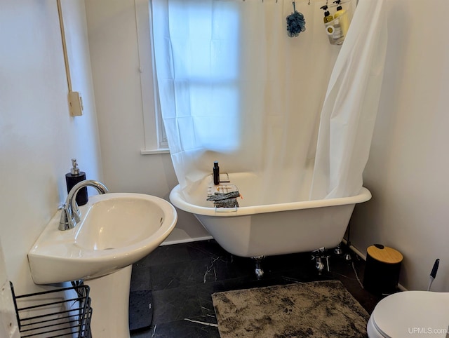 bathroom with a bathing tub and toilet