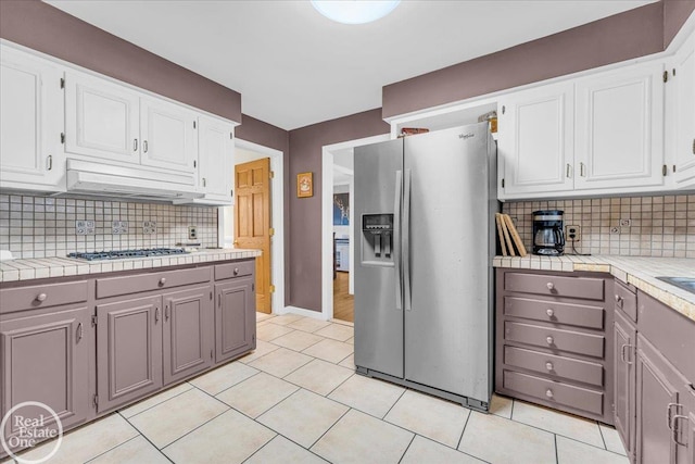 kitchen with gray cabinetry, white cabinetry, stainless steel appliances, and tile counters