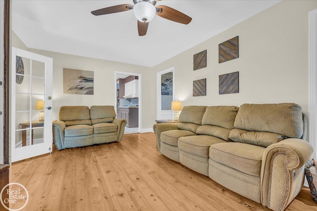 living room featuring ceiling fan and hardwood / wood-style floors