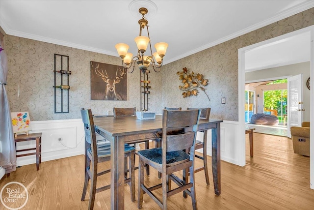 dining room with wood-type flooring, crown molding, and a chandelier