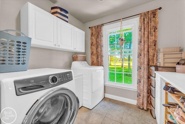 laundry room with separate washer and dryer, cabinets, and light tile patterned floors