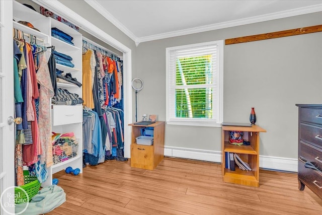 walk in closet featuring light hardwood / wood-style floors and a baseboard heating unit