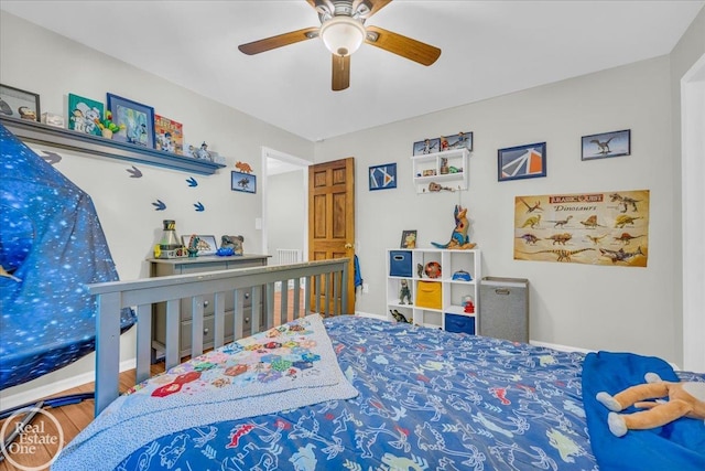 bedroom with hardwood / wood-style floors and ceiling fan