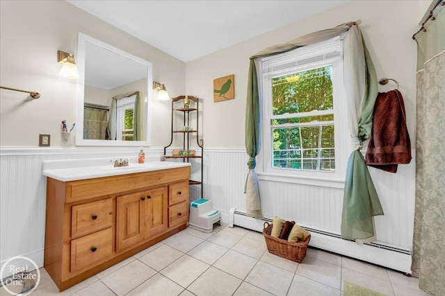 bathroom with vanity, a shower with shower curtain, a baseboard radiator, and tile patterned floors