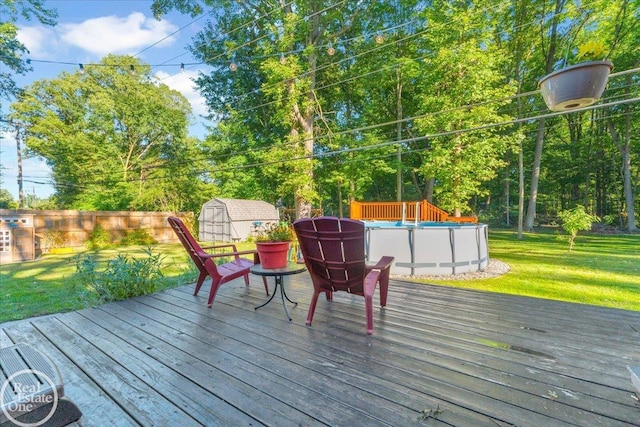 deck featuring a shed and a yard