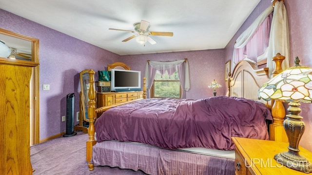 bedroom featuring ceiling fan, baseboards, carpet, and a textured wall