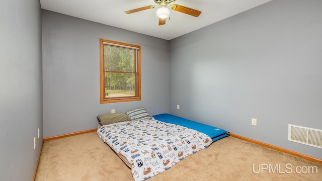 carpeted bedroom featuring visible vents, ceiling fan, and baseboards