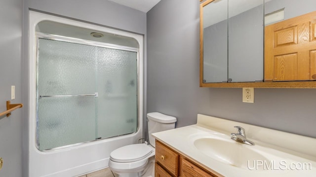 full bathroom with bath / shower combo with glass door, vanity, and toilet