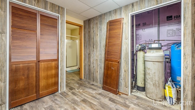 hallway featuring light hardwood / wood-style flooring and a paneled ceiling