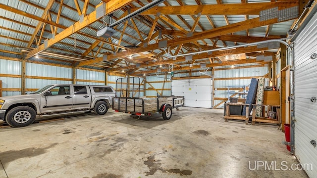 garage featuring metal wall and a garage door opener