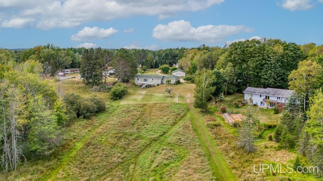 aerial view featuring a wooded view